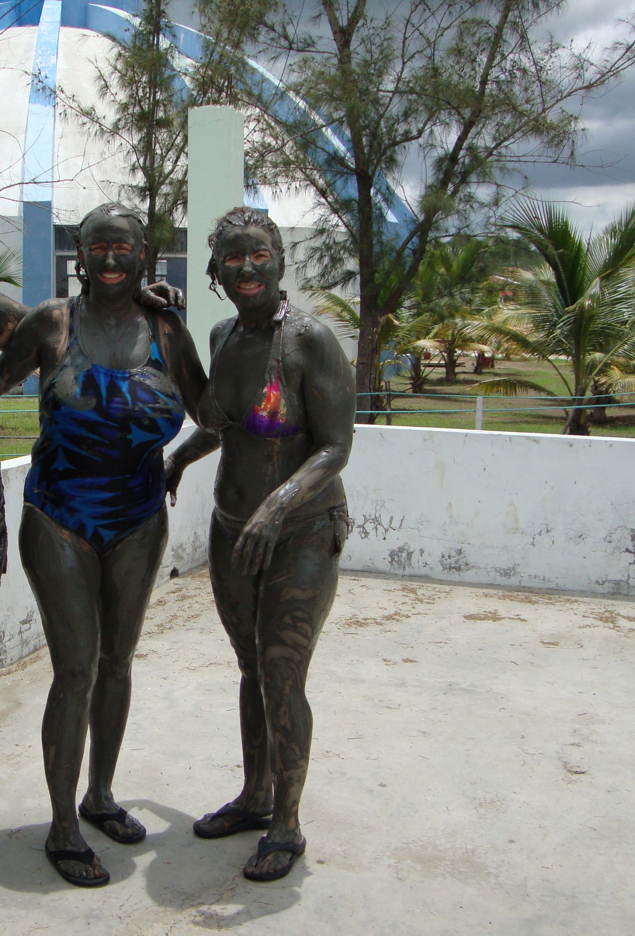 Two women covered in mud