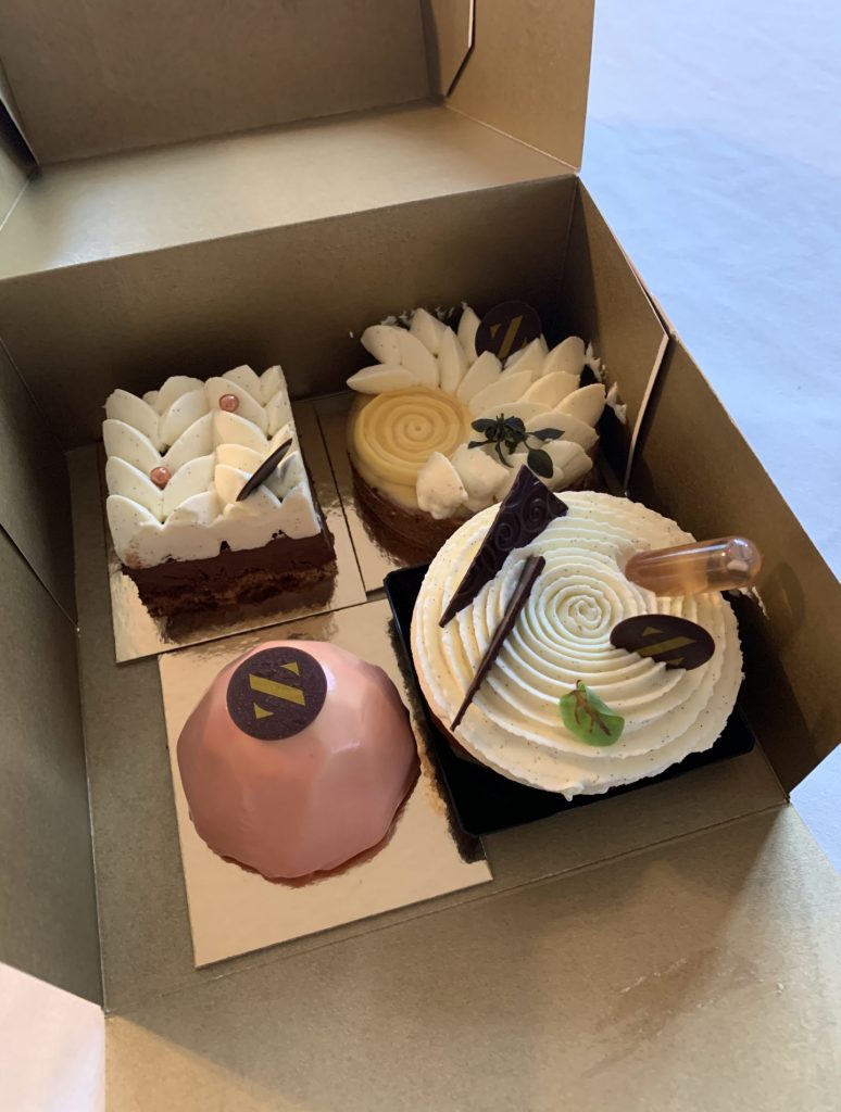 Four cakes in a box. Pastries.
