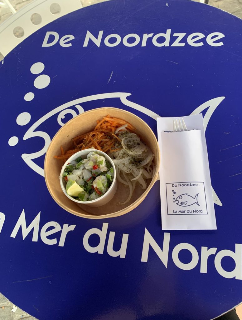 Paper bowl with a fish and a salad