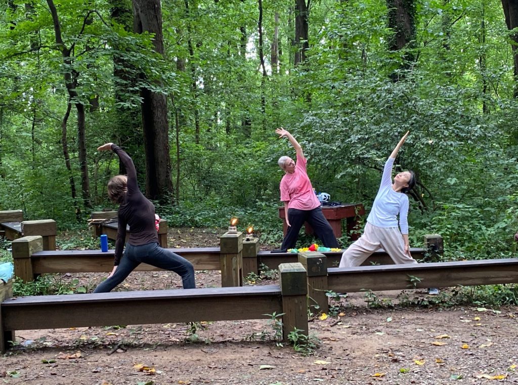 Fierce in the forest. Women exercising in nature.