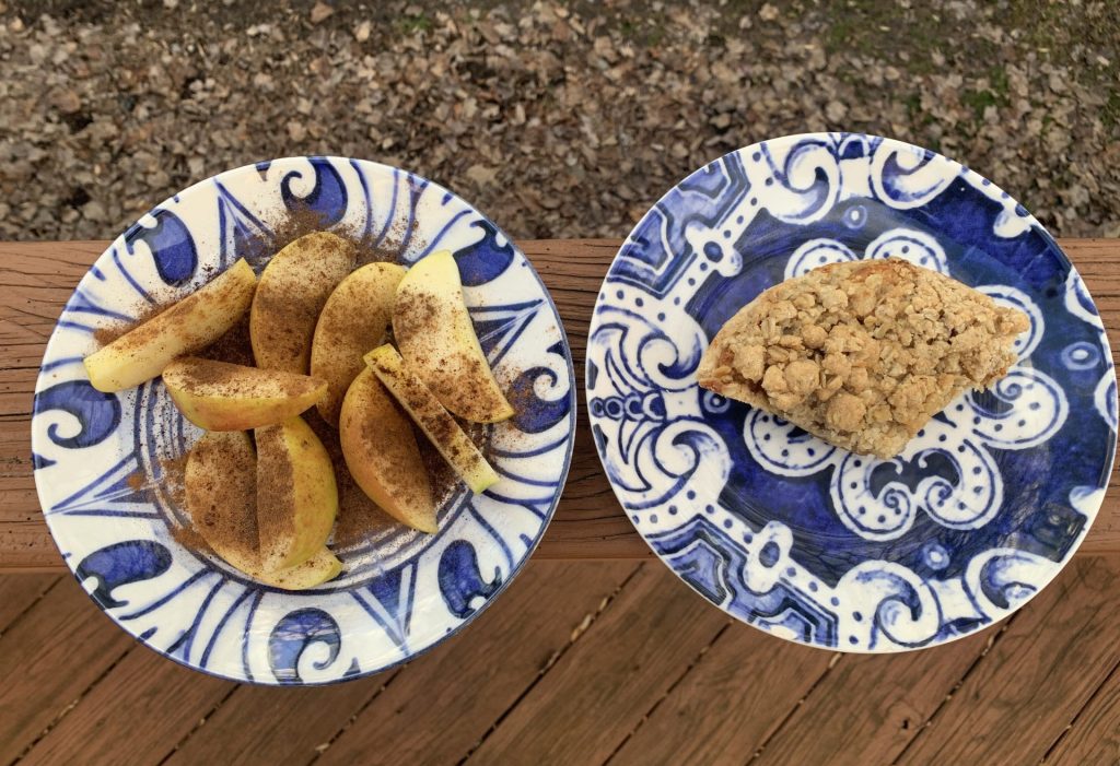 Two plates, one with cut apple and cinnamon, the other with a slice of apple crumble pie