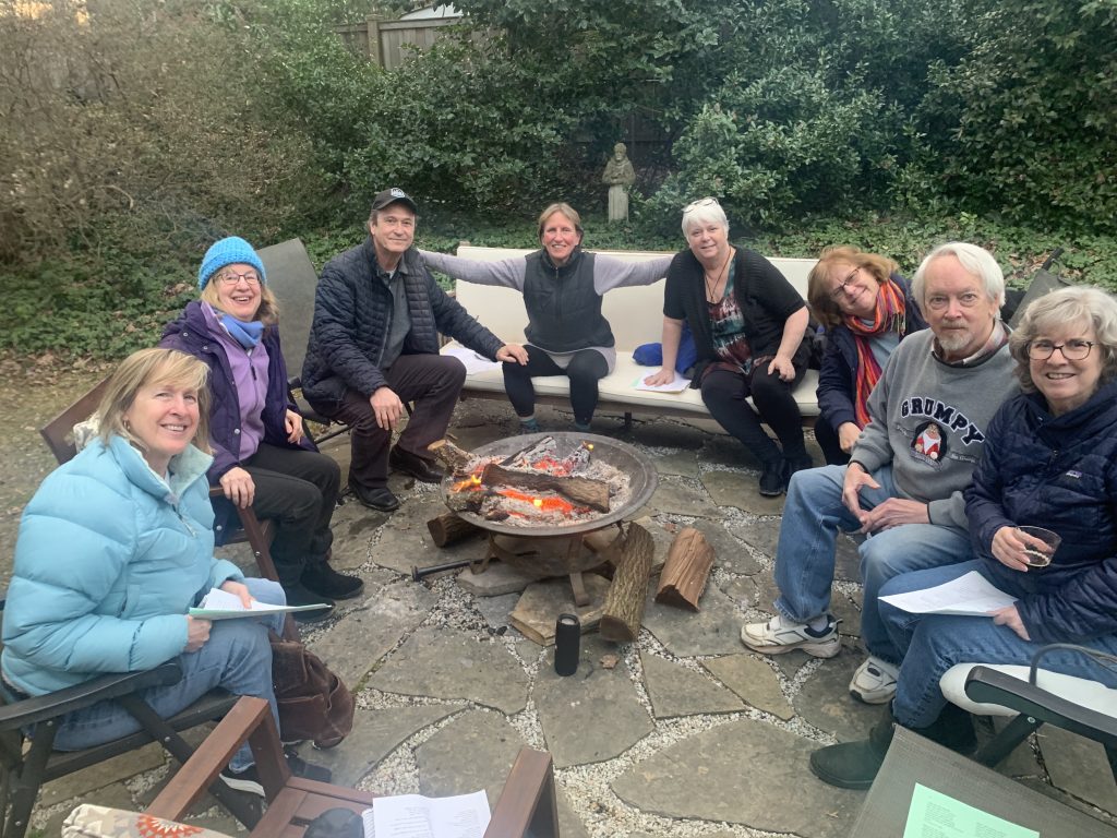 People sitting around a fire at a sing-along