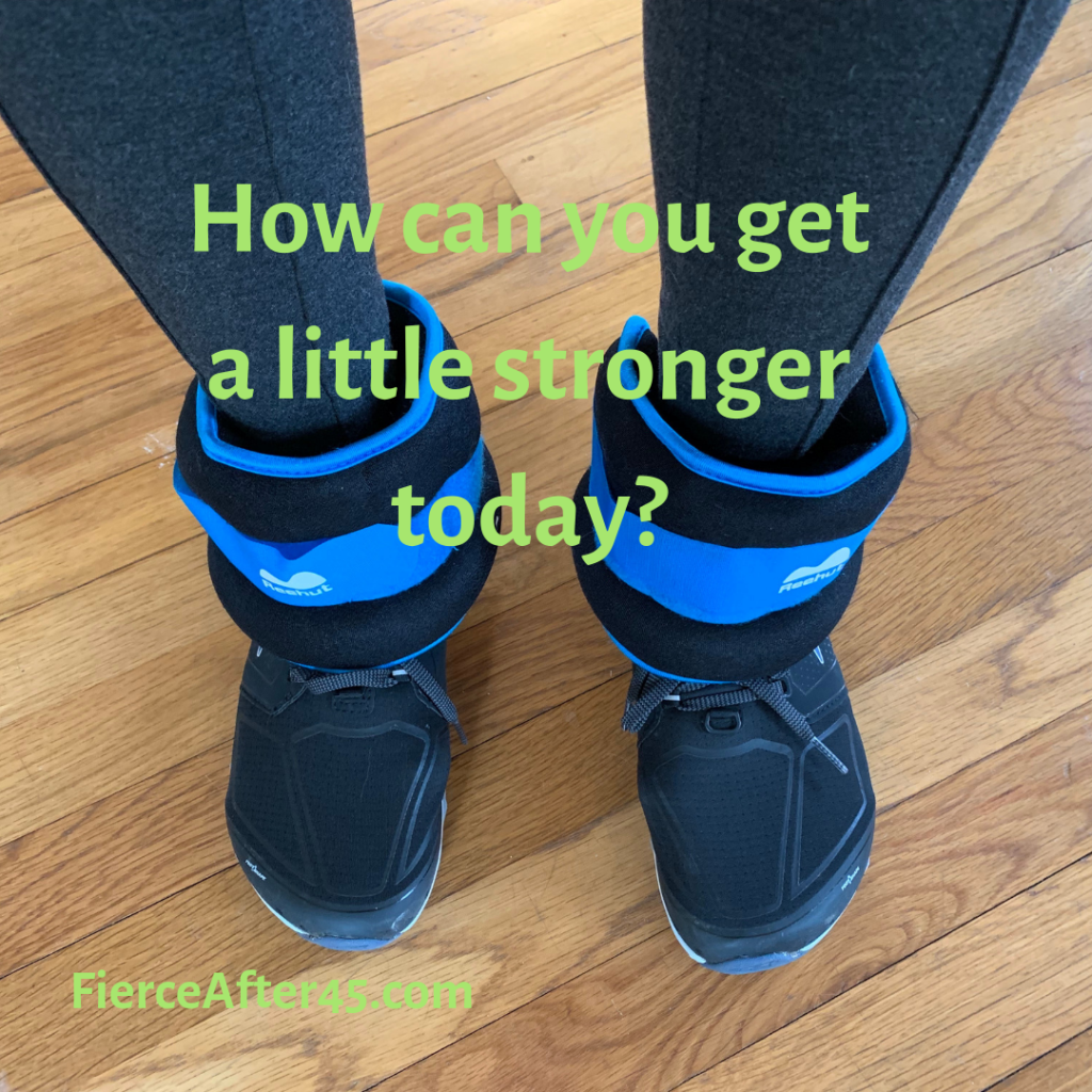 Image of the author's feet with ankle weights and the caption "How can you get a little stronger today"?