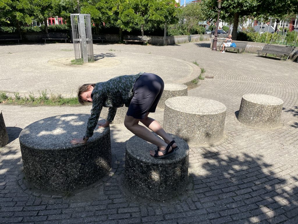 The author doing a bear crawl on playground structures