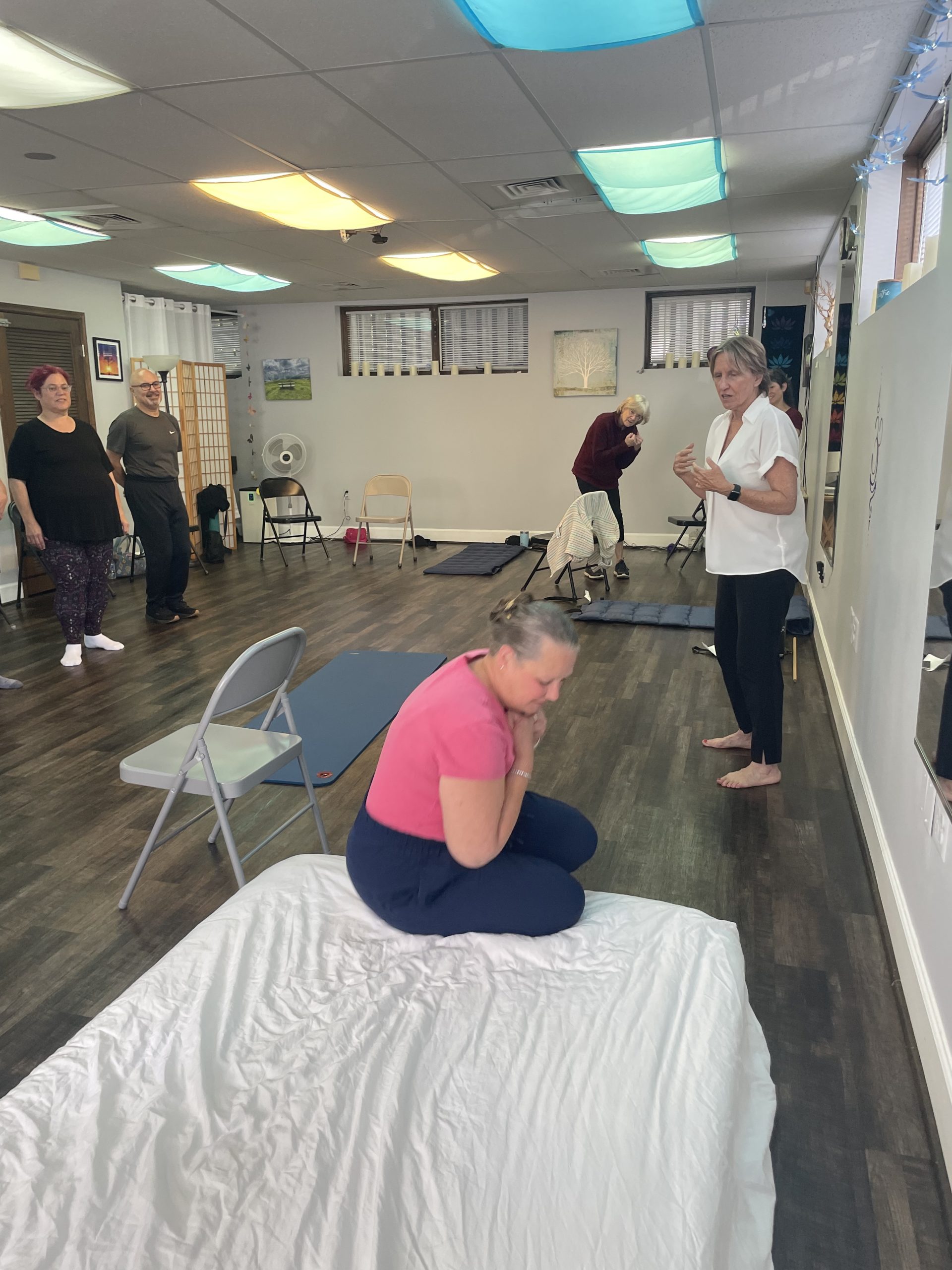 A woman practicing falling on a mattress